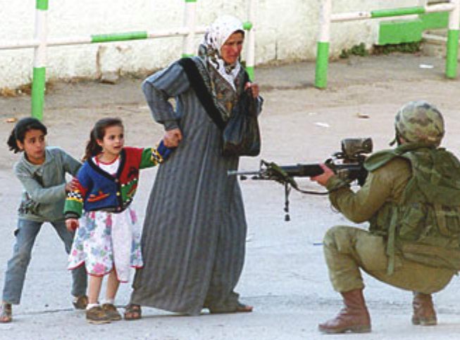 palestine_oppression_soldier_patrol_mother_protecting_children.jpg
